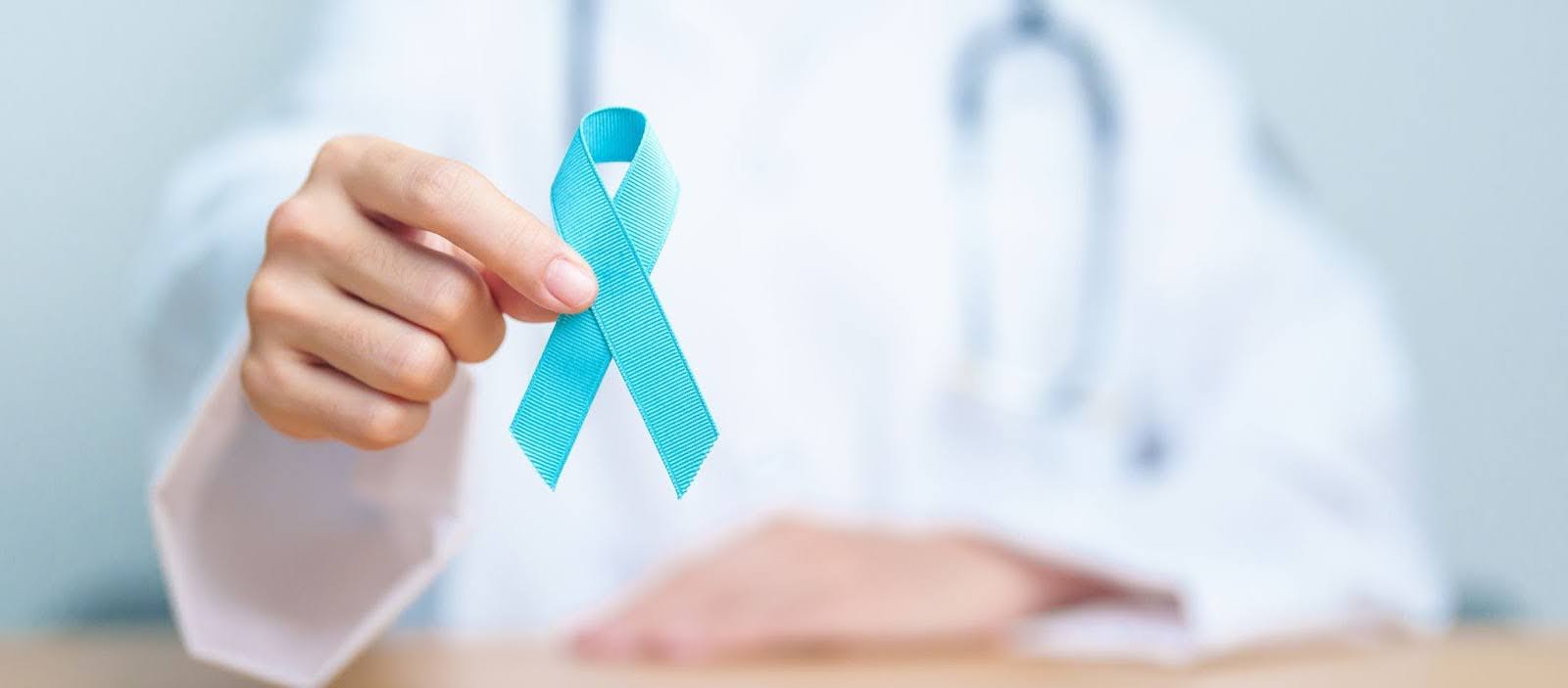 Man holds prostate cancer awareness ribbon