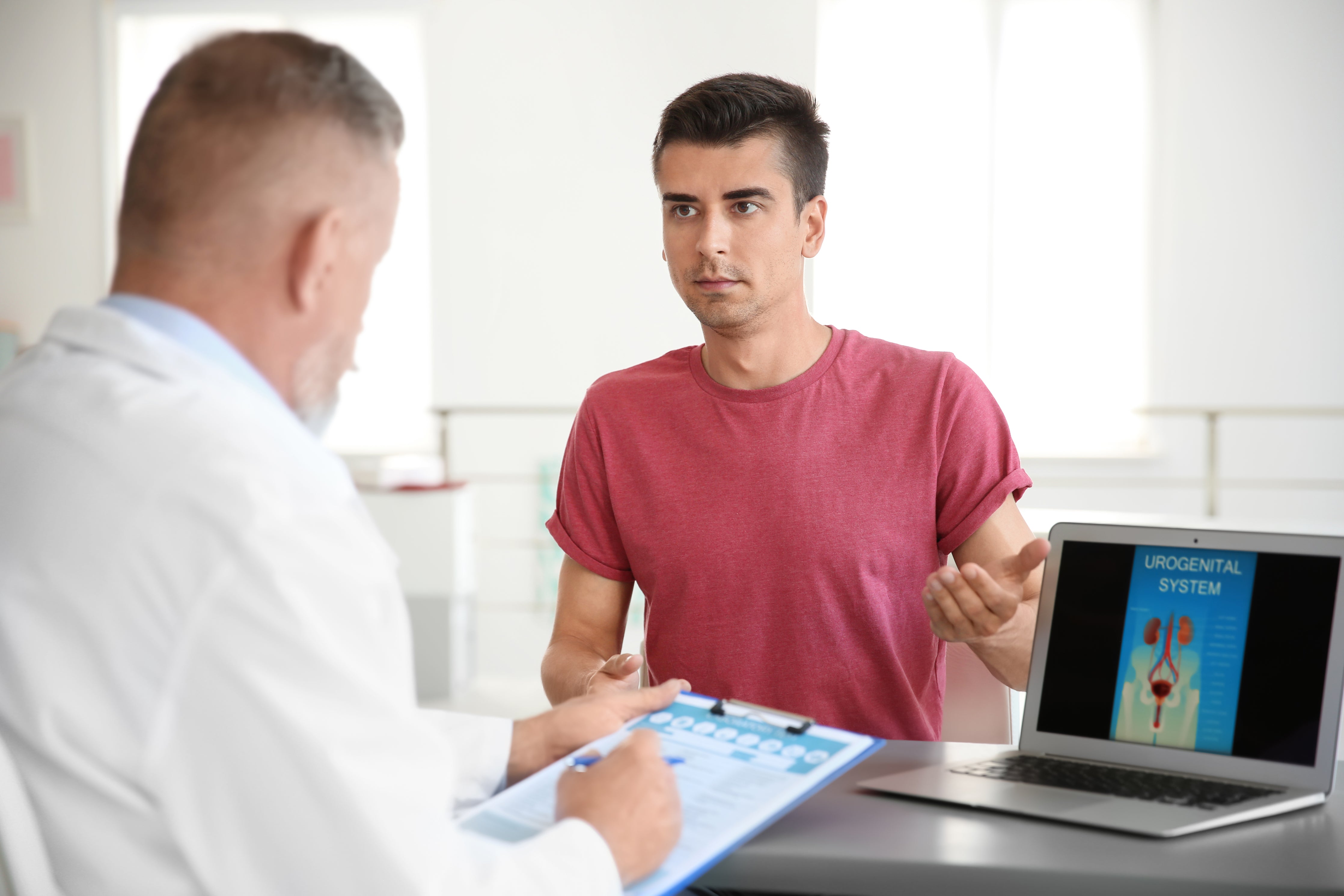 Urologist discussing prostate cancer treatment options with male patient.