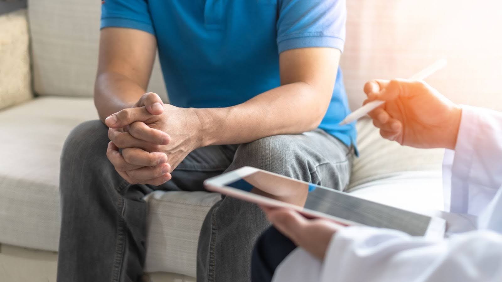 Doctor and male patient discussing how to check for prostate cancer at home.