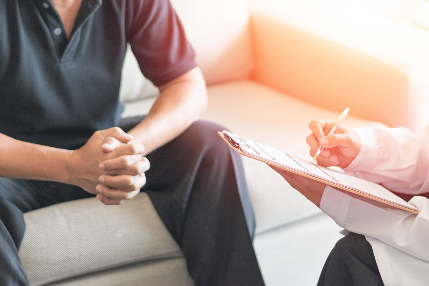 Doctor talking to patient after reviewing details from prostate volume calculator.