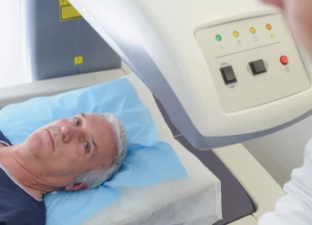 Older male patient talking to a doctor before undergoing a prostate MRI