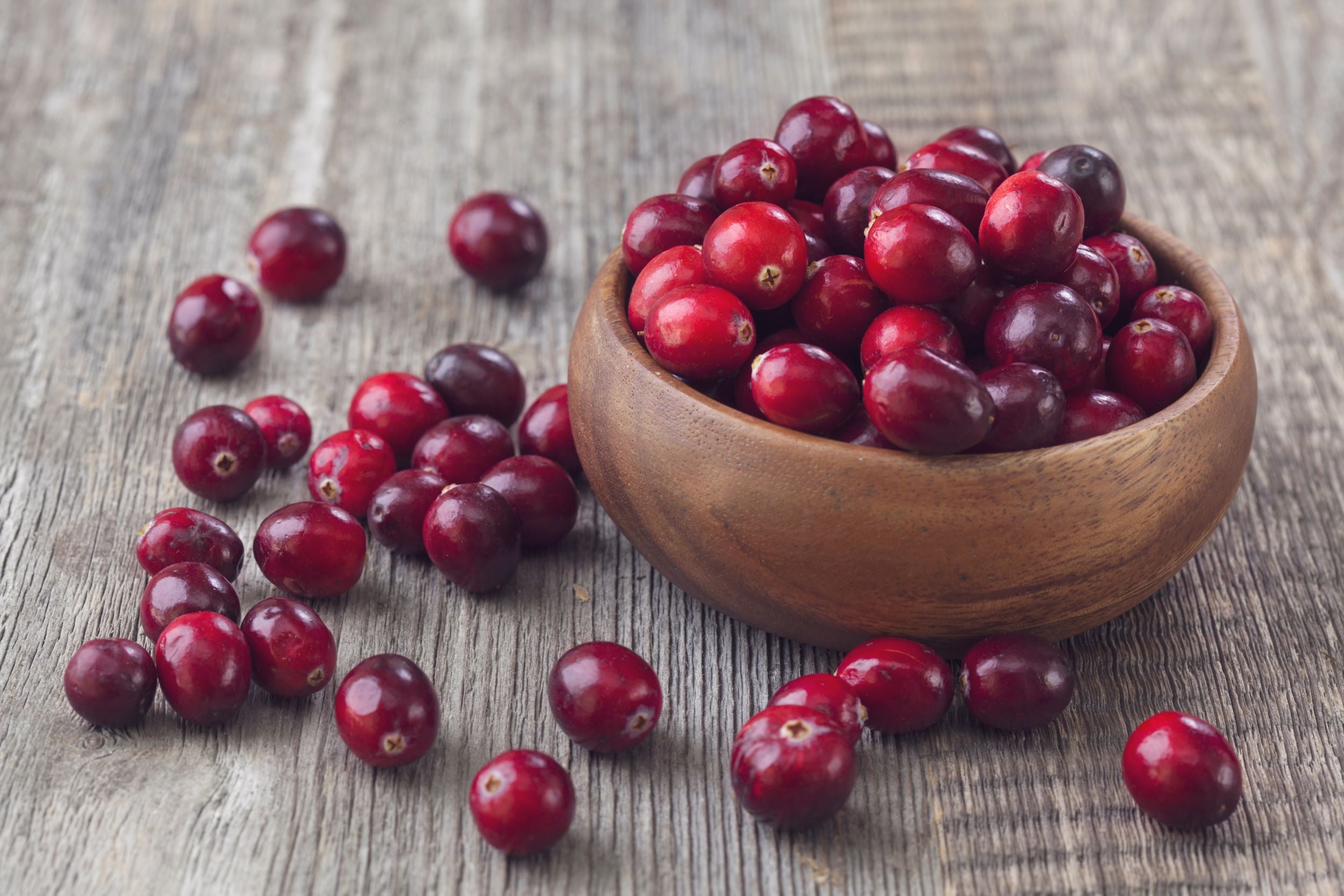 Close up of cranberry fruit in a wooden bowl